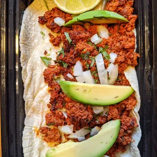 Tacos Chorizo: Carniceria Azteca chorizo, onion, avocado, cilantro.