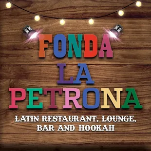 a wooden sign with string lights