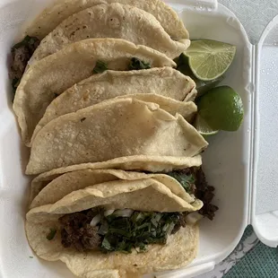 four tacos in a styrofoam container