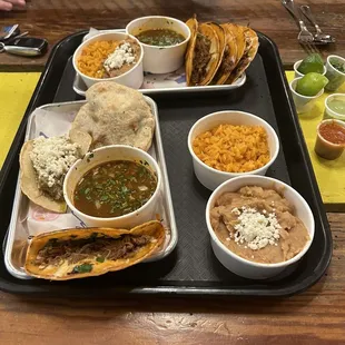 A spread full of delicious bites including the Quesabirrias, Gorditas, and Taco de Guiso!