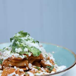 Chilaquiles - Crispy tortillas tossed with your choice of red or green sauce.