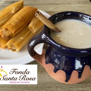 a plate of mexican food and a mug of milk