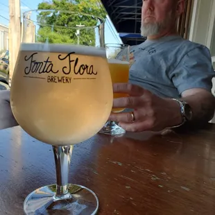 a man holding a glass of beer