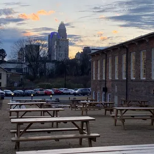 a row of picnic tables in a parking lot