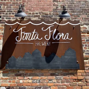 a sign on a brick wall