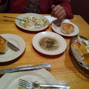 Salads and handmade rolls with dipping oil