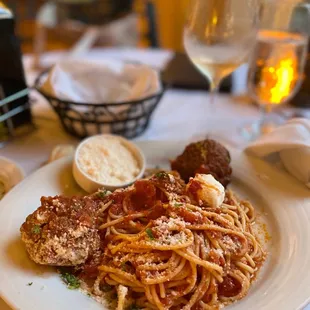 SPAGHETTI ALLA CHITARRA CON POLPETTE Nonna&apos;s meatballs slow cooked in tomato gravy, spaghetti, ricotta cheese
