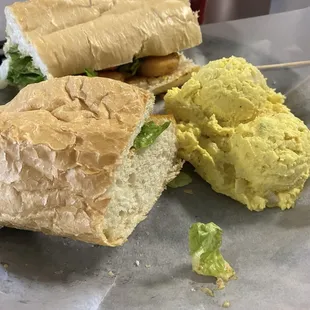 Fried shrimp po&apos;boy with potato salad. The French bread is from New Orleans.