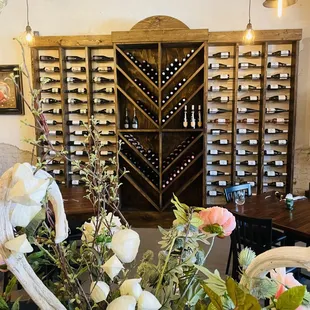 a wine rack and flowers