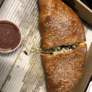 Huge calzones! Packed full of toppings. No sauce on the inside, but they give you a side of marinara.