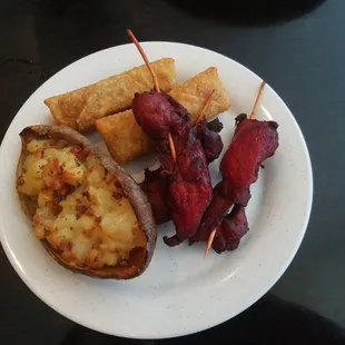 Stuffed Potato, egg rolls, and chicken on a stick.