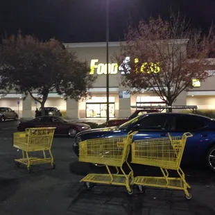 three shopping carts in a parking lot