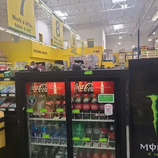 a soda cooler in a grocery store