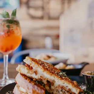 a grilled sandwich and a drink