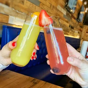 two people toasting drinks