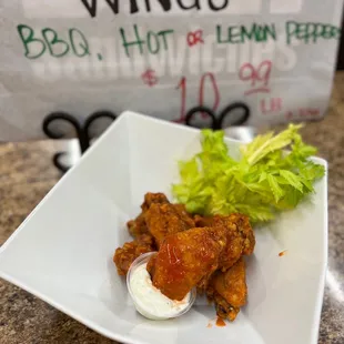 a plate of wings and a salad