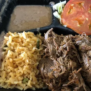 The red chili birria with rice and beans on the side.   Taste awesome