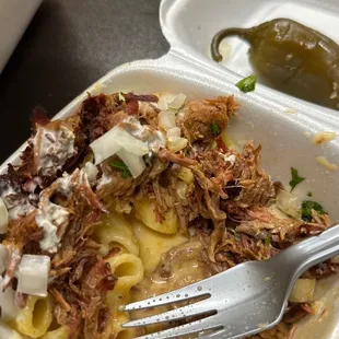 Mac and topped w slow cooked pork w onions