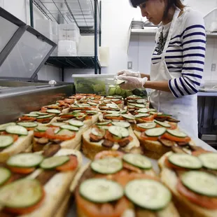 a woman making sandwiches