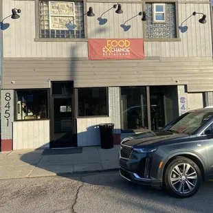 a car parked in front of a restaurant