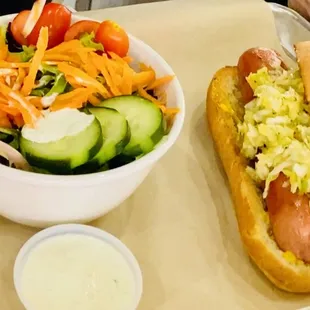 Hot dog with side of salad.