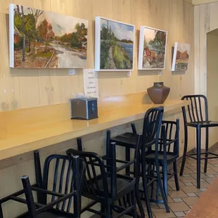 a row of chairs at a counter
