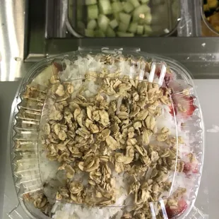 a container of granola, fruit, and yogurt