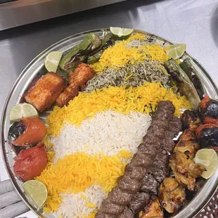 Salmon with top sirloin, boneless chicken, thigh, and koobideh served with half white rice and half baghali polo rice
