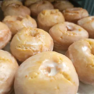 a tray of glazed donuts