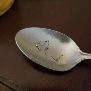 a silver spoon with a heart drawn on it