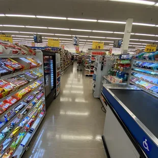 a grocery store aisle with refrigerators