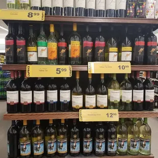bottles of wine on shelves in a grocery store