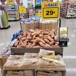 a display of sweet potatoes in a grocery store