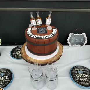 a birthday cake with liquor bottles
