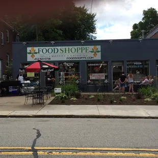 people sitting at tables outside