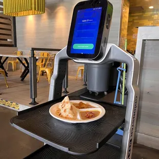 Robot bringing out the Curry Chicken Roti Plate