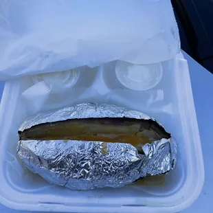 a hot dog wrapped in foil