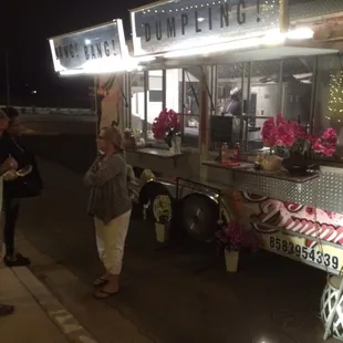 people standing outside at night