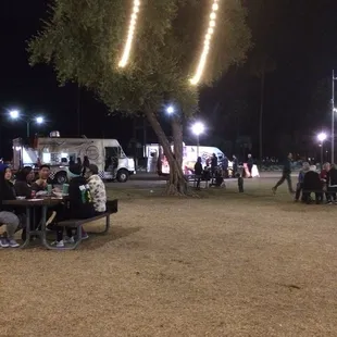 people sitting at picnic tables