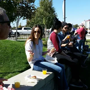 people eating hot dogs