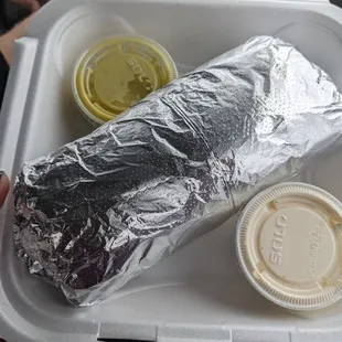 a burrito in a styrofoam container