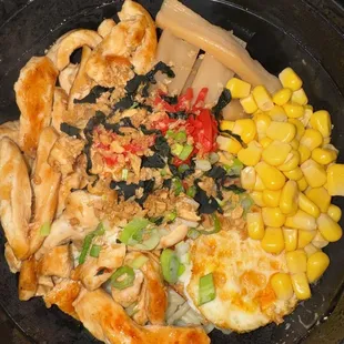 chicken, corn, and vegetables in a skillet