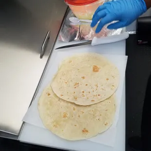two tortillas being prepared