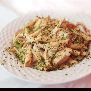 a plate of pasta with chicken and vegetables