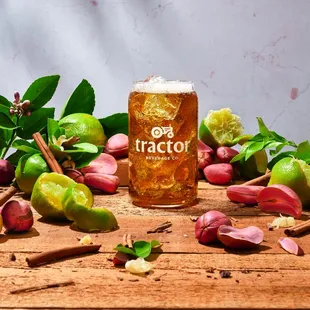 a pint of beer next to a bunch of fruit