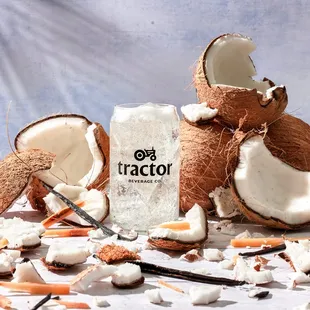 a broken coconut and a bottle of tractor