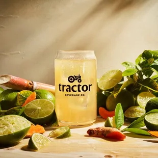 a can of tractor surrounded by limes, carrots, and gingers