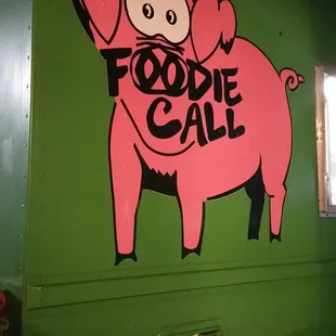 a pink pig on a green truck