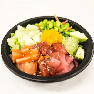 a black bowl of food on a white table