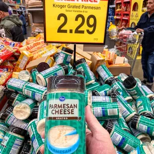 a person holding a bottle of cheese sauce